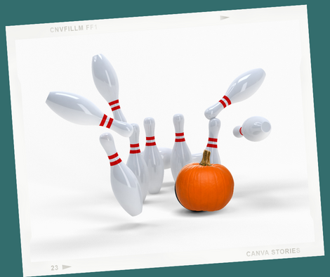 a pumpkin bowling down a group of bowling pins